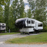 View of clean RV, level RV site with full hookups and picnic table at Rivertown Rose Campground, Vicksburg, Mississippi