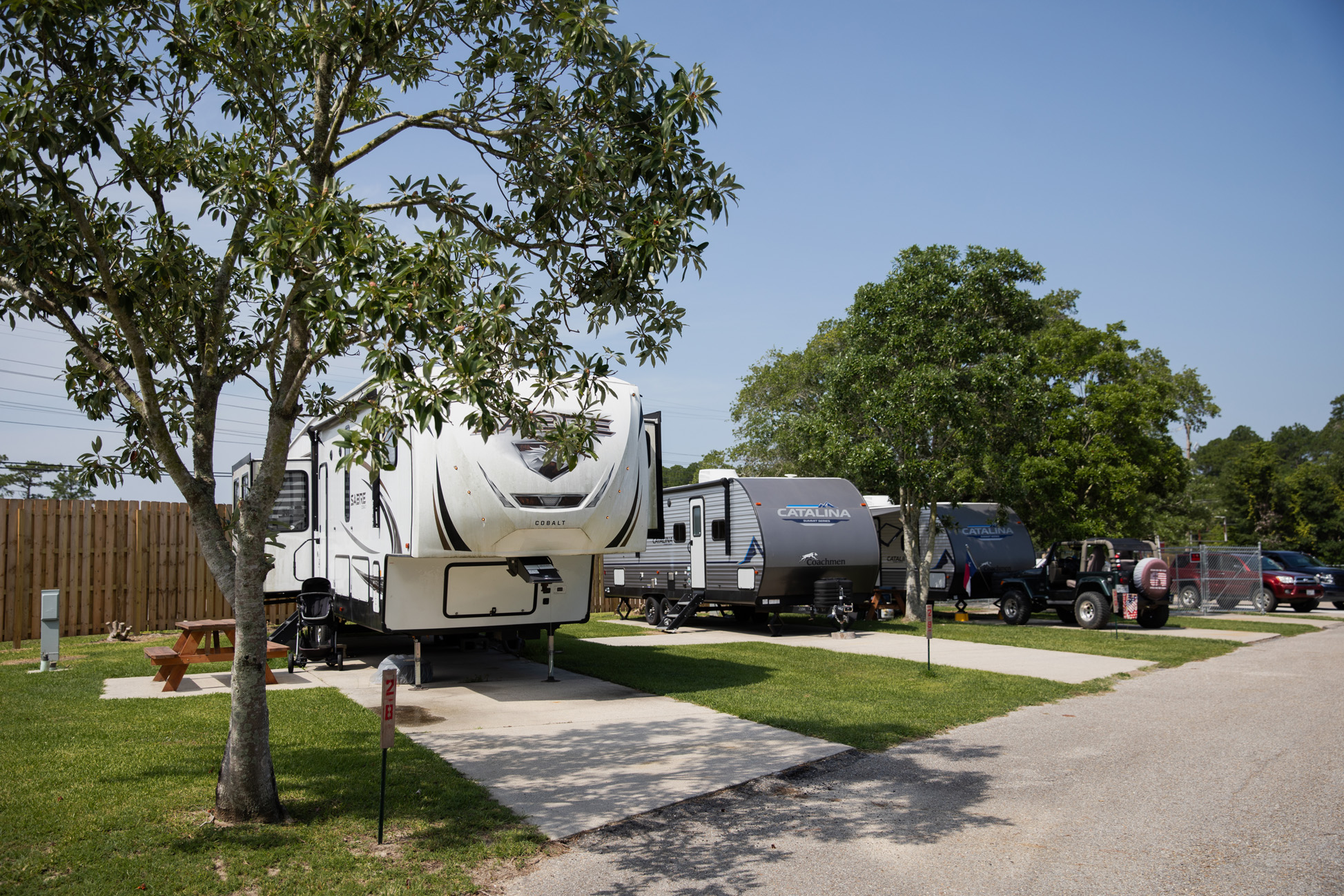 Quiet RV camping sites with hookups, level concrete pads, picnic tables, and lawn at Bayberry RV Park in Gulfport, MS