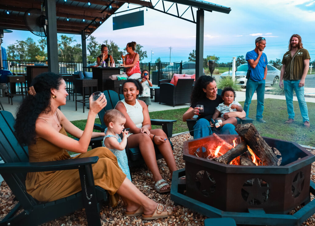 Guests gathered around the fire on a mild evening at one of Streamside's snowbird friendly parks.