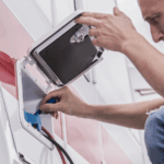 Man working to winterize RV for cold weather camping