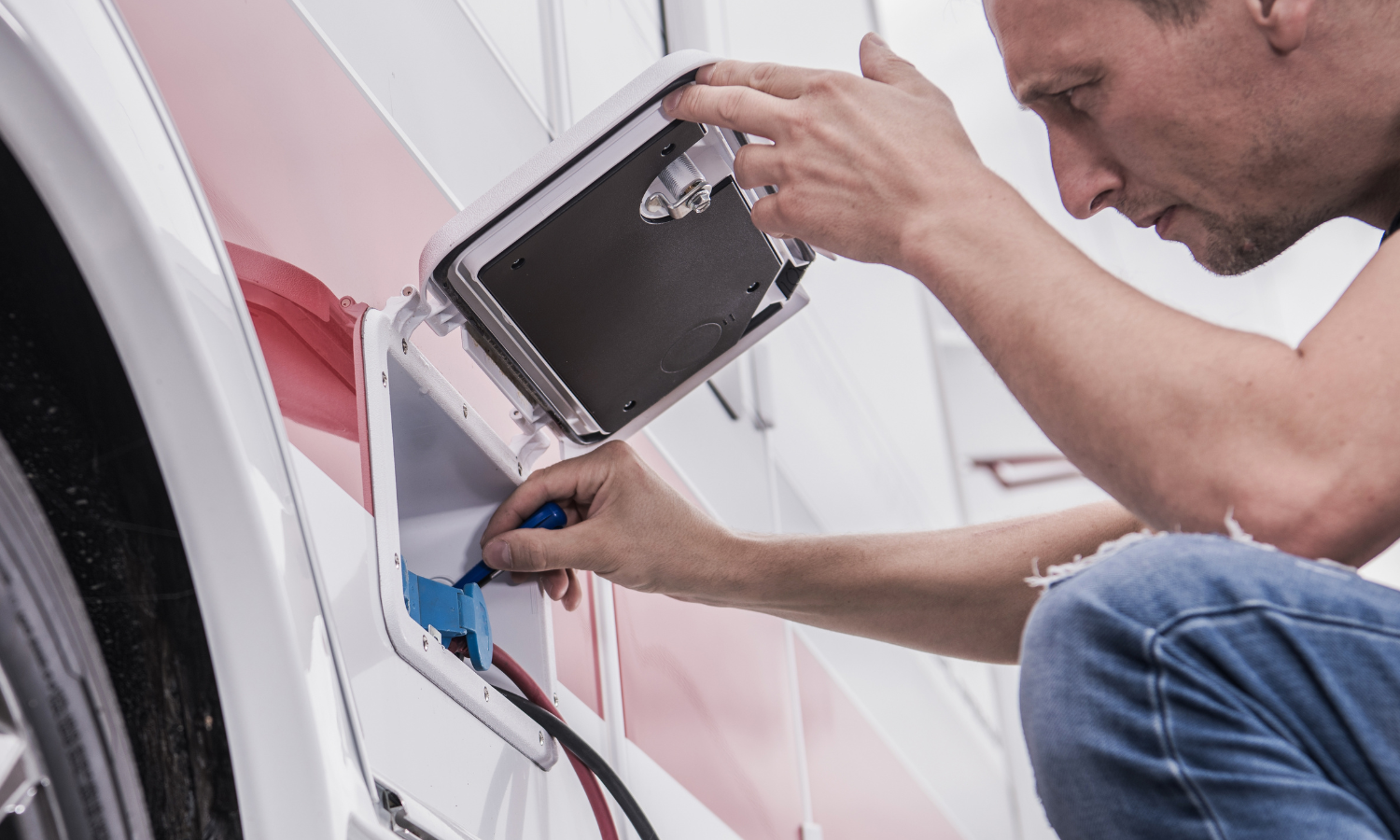 Man working to winterize RV for cold weather camping