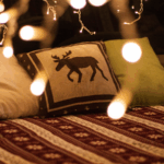 Cozy holiday RV trip decorated space with twinkle lights and festive bedspread