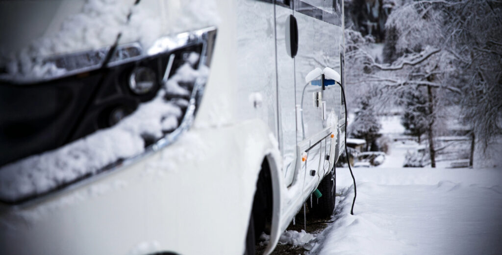 An RV in Winter Parked in a Streamside Campground