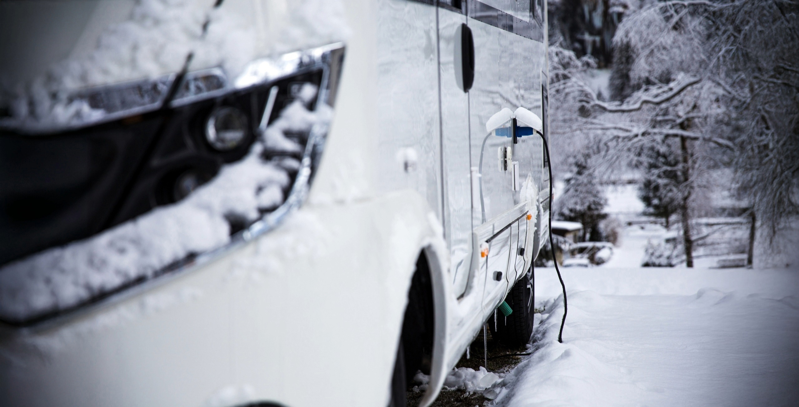 An RV in Winter Parked in a Streamside Campground
