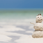 Snowman made of sand at the beach during winter along the Mississippi Gulf Coast.