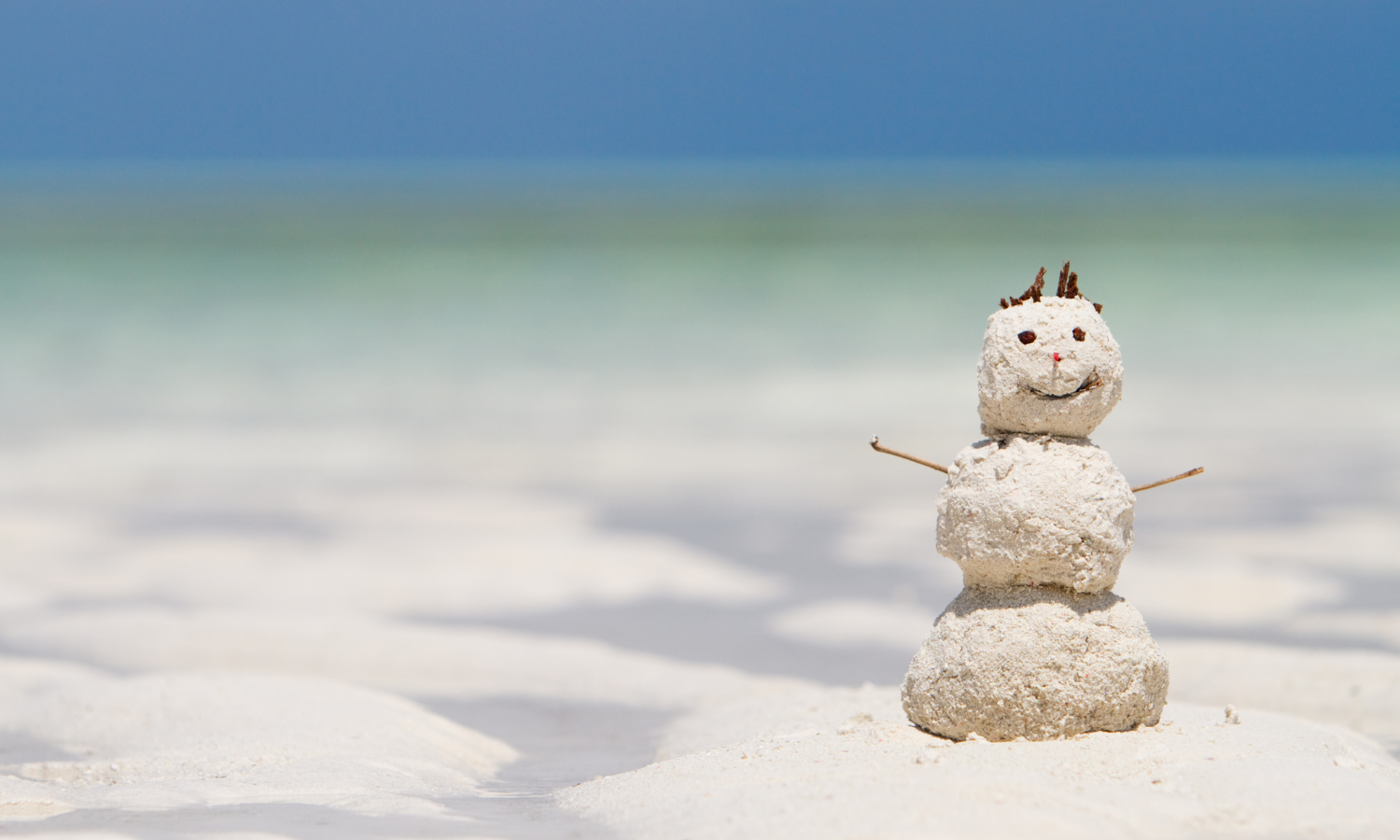 Snowman made of sand at the beach during winter along the Mississippi Gulf Coast.