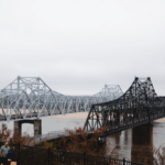 Scenic view of the Mississippi River bridges inviting travelers to visit Vicksburg during the winter season.