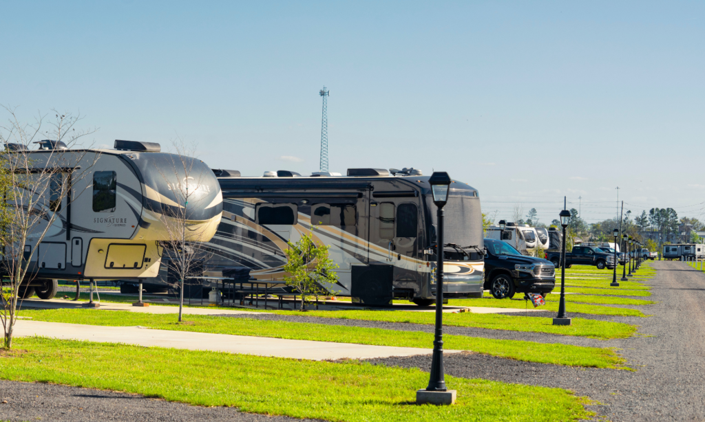 Big rig RVs parked on spacious concrete sites at The Station RV Resort in Madison, Florida