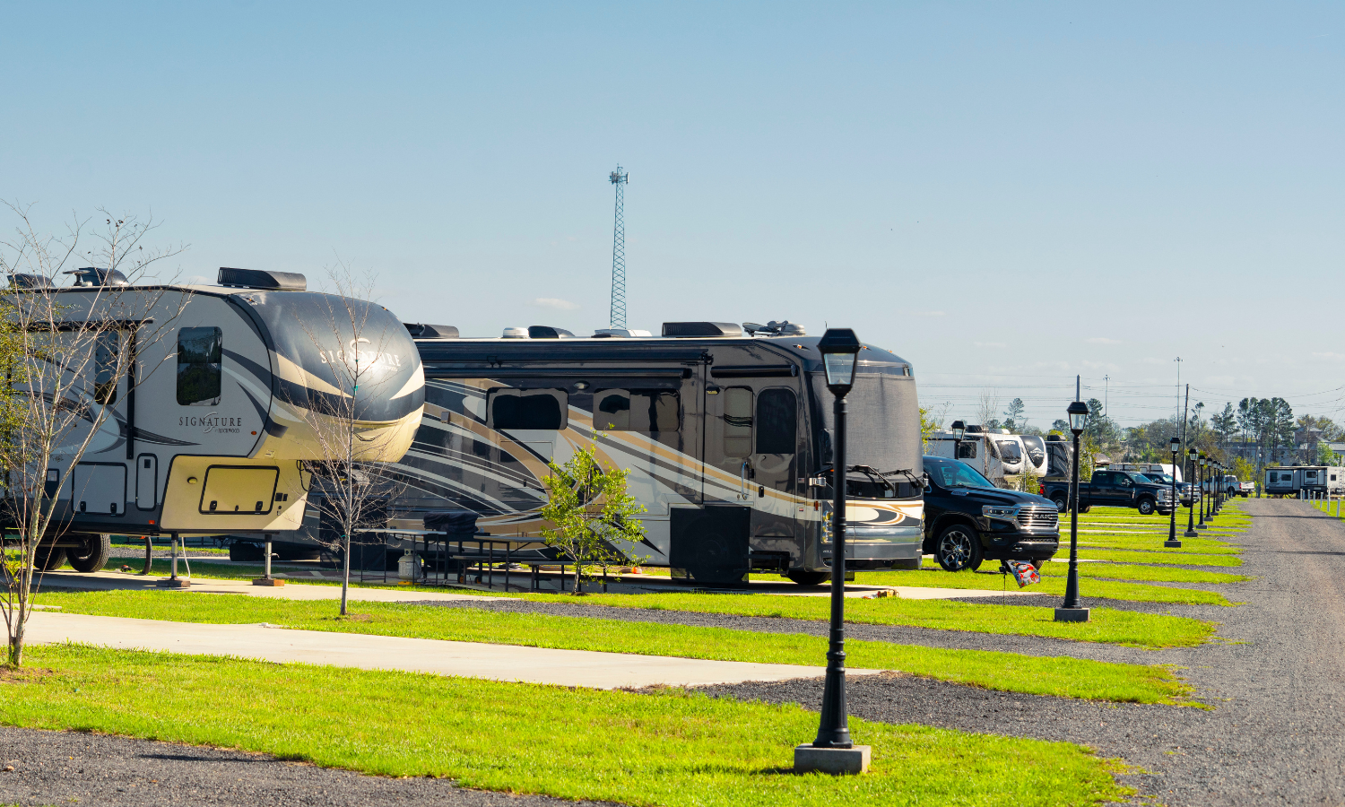 Big rig RVs parked on spacious concrete sites at The Station RV Resort in Madison, Florida