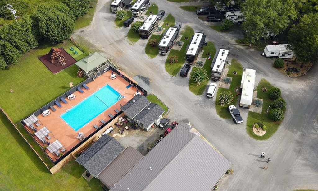 Overhead view of Twin Oaks RV Park in Elko, GA showing spacious RV sites, pool area, playground, and open lawn space for games and outdoor activities.