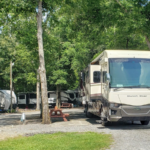 Summer RV parked at a shaded full-hookup site at Twin Oaks RV Park in Middle Georgia during sunny summer camping season.