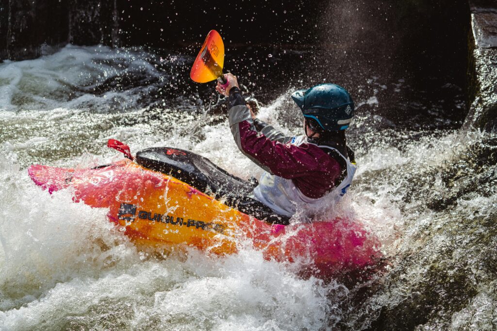 River kayaker in the rapids at the Bigfork Whitewater Festival, just outside Polson, Montana.