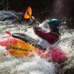 River kayaker in the rapids at the Bigfork Whitewater Festival, just outside Polson, Montana.