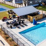 Aerial view of The Station RV Resort featuring the swimming pool, pickleball courts, and The Filling Station grilling and picnic area in Madison, Florida