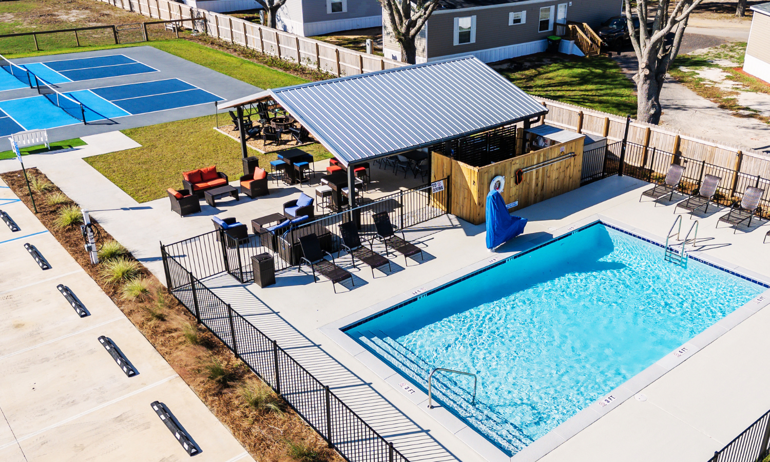 Aerial view of The Station RV Resort featuring the swimming pool, pickleball courts, and The Filling Station grilling and picnic area in Madison, Florida