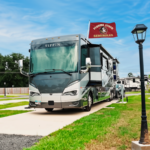 RV in a pull-through spacious site at The Station RV Resort in Madison, Florida, with a Florida State Seminoles flag flying above the RV.
