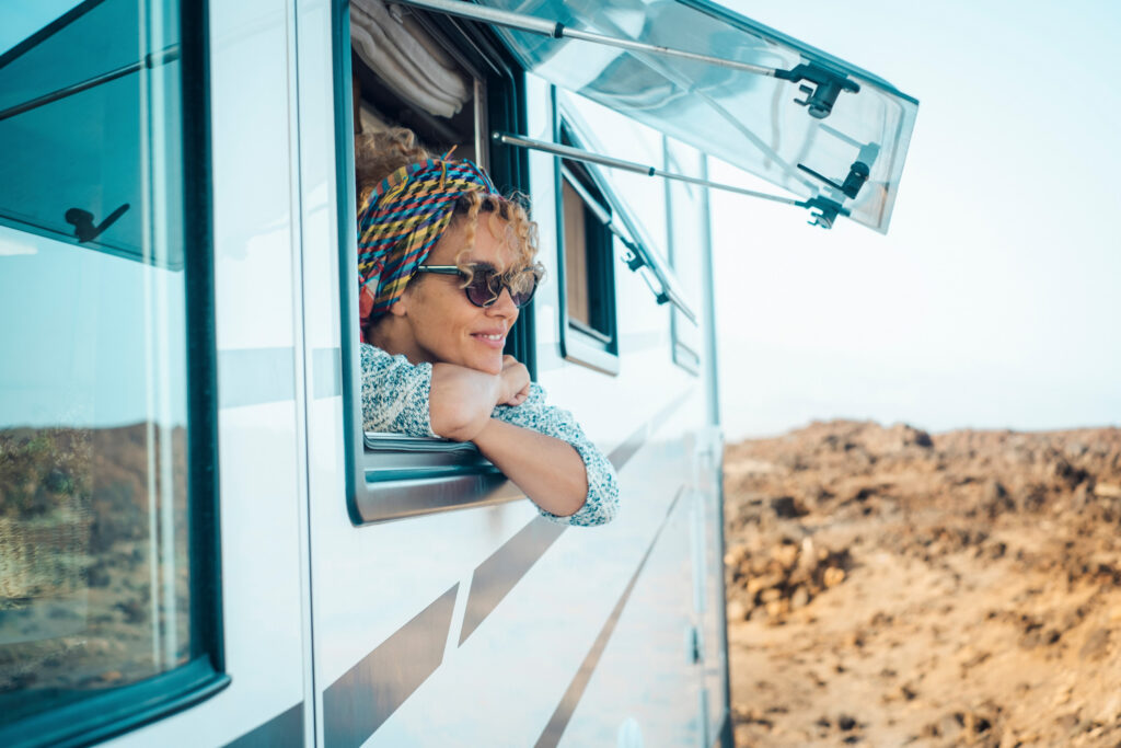 Woman gazing out of her RV at the view of the Coachella Valley in winter.