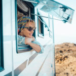Woman gazing out of her RV at the view of the Coachella Valley in winter.