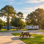 RV campsites at Bayberry RV Park in Gulfport, Mississippi, surrounded by trees and warm afternoon sunlight.